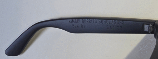 Close up of the engraving on the inner left arm of the matte black square sunglasses from Kimchi Burrito Sunglasses.