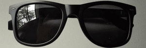 Close-up of Kimchi Burrito BLK-01 matte black sunglasses, on a neutral background.