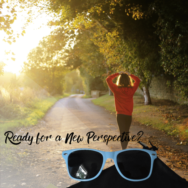 Lifestyle image showing a person from behind, seemingly contempating a sun-drenched, tree-lines path, with a pair of light blue sunglasses positioned prominently in the lower foreground. The overlay text ready "Ready for a New Perspective?"